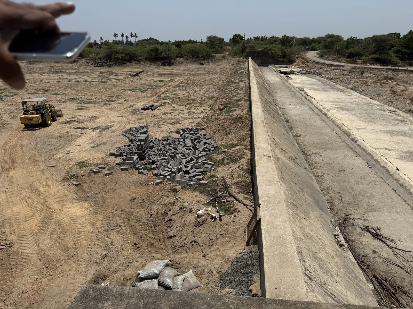 A completed concrete recharge weir running across the dry Nagmati riverbed